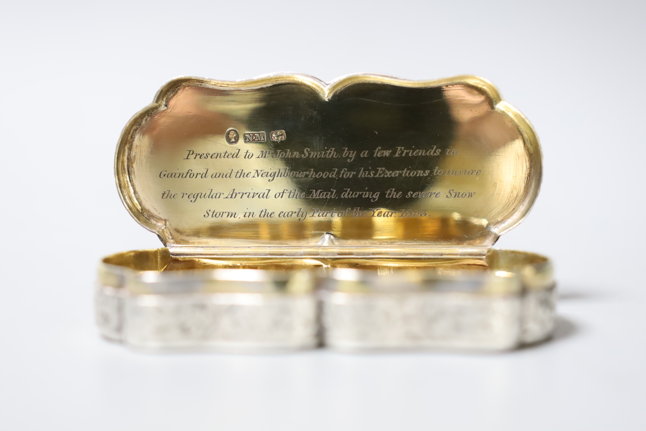 A Victorian engraved silver shaped oval snuff box, by Nathaniel Mills, Birmingham, 1840, with later engraved inscription, 95mm.